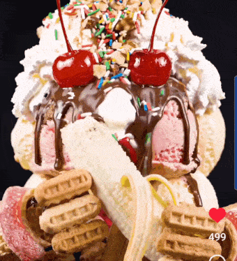 a giant ice cream sundae with a banana and cherry on top