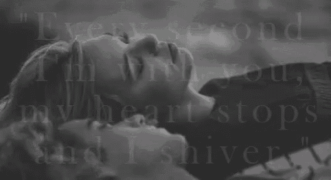 a black and white photo of two people laying next to each other with the words " every second i 'm with you "