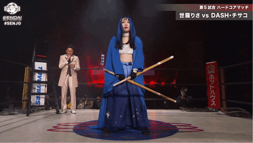 a woman in a blue dress holds two sticks in front of a sign that says sendai #senjo