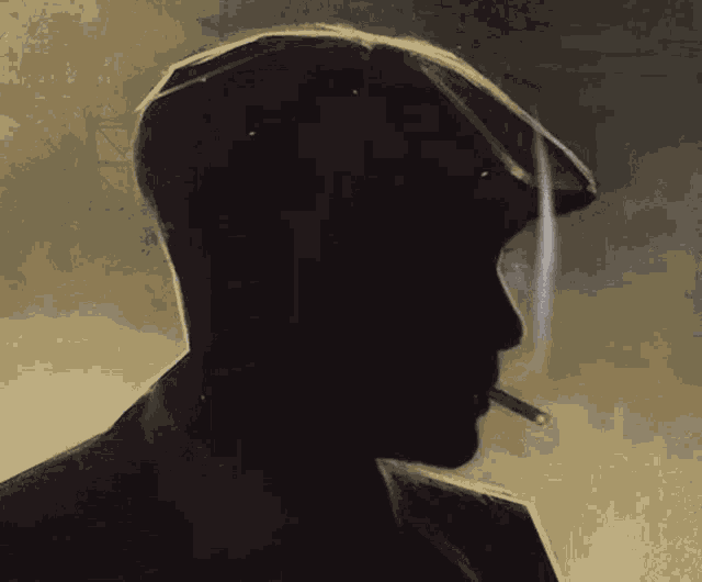 a silhouette of a man wearing a hat and smoking a cigarette