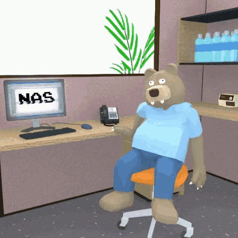 a teddy bear sits in front of a computer screen that says nas