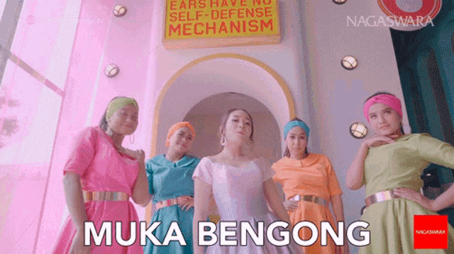 a group of women are standing in front of a sign that says self defense mechanism