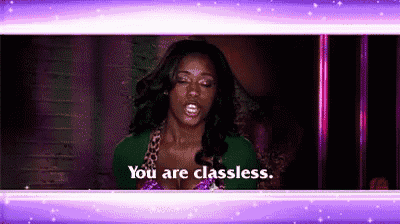 a woman is standing in front of a purple background and saying `` you are classless . ''