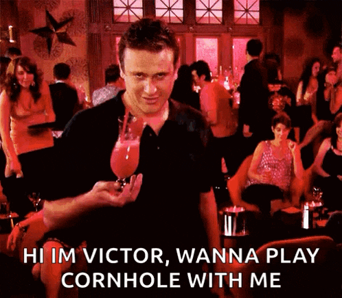 a man is holding a glass of wine and says hi im victor wanna play cornhole with me .