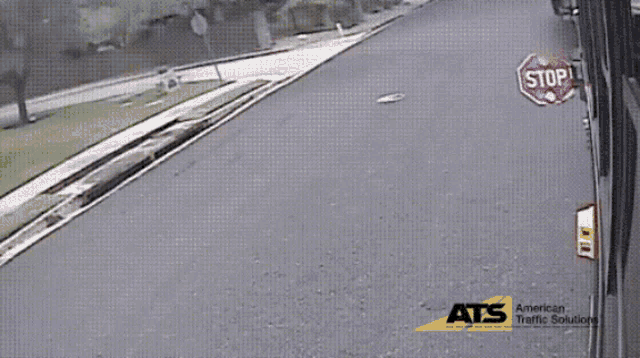 a stop sign is on the side of the road next to an ats logo