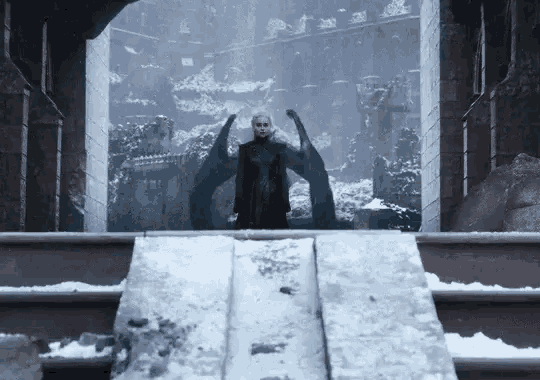 a woman with dragon wings is standing on a snowy staircase