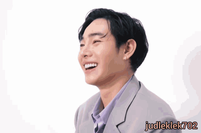a man in a suit is laughing with the name judleklek702 on the bottom