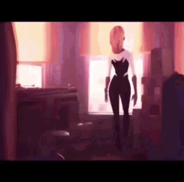 a woman is standing in front of a window in a room .