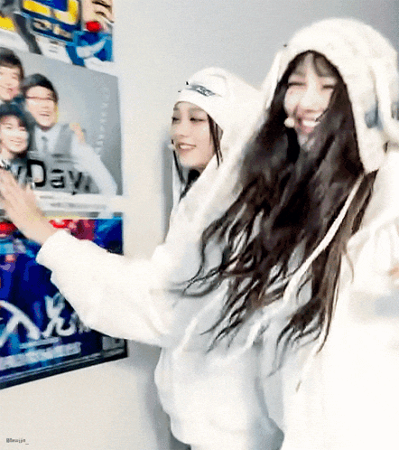 two girls are standing in front of a poster that says day on it