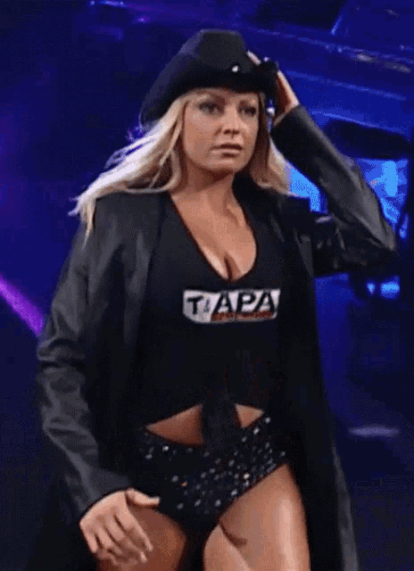 a woman wearing a black top that says tapa