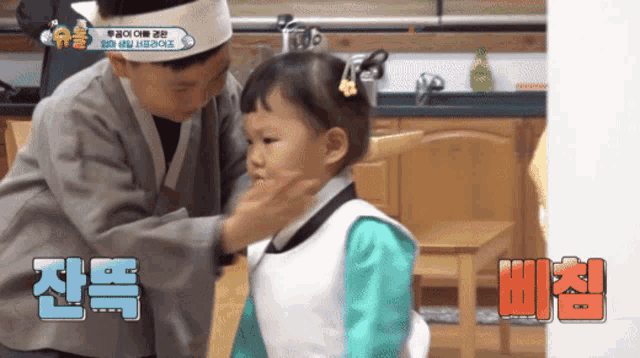 a boy is putting a bandage on a young girl 's head