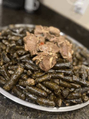 a tray of food with a piece of meat on top