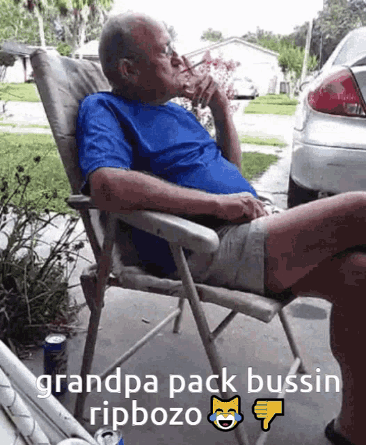 a man in a blue shirt is sitting in a chair with a can of soda in front of him