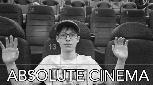 a black and white photo of a man sitting in a theater with the words absolute cinema behind him