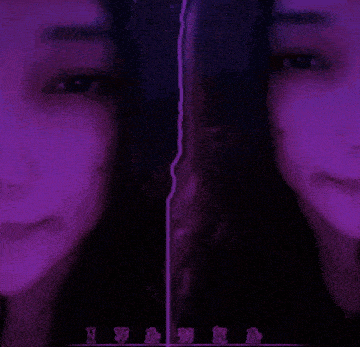 a woman 's face is split in half by a purple line