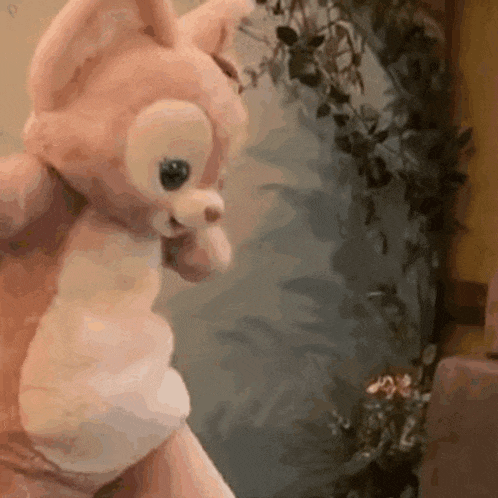 a close up of a person holding a stuffed animal in their hands .