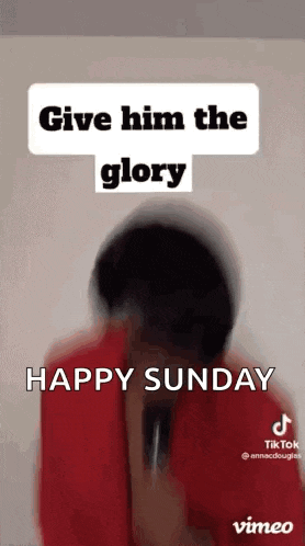 a man in a red shirt is holding a microphone and says `` give him the glory '' .