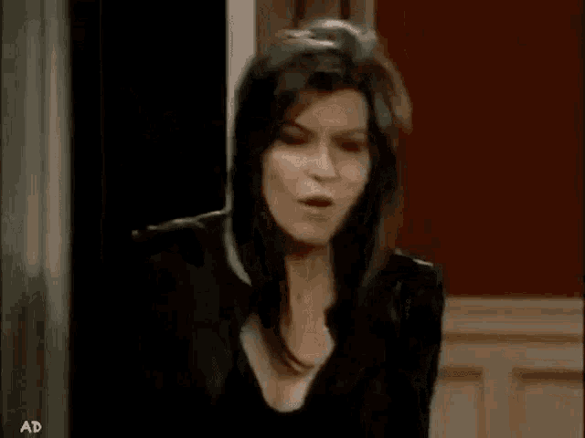a woman is making a funny face and sticking her tongue out .