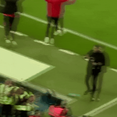a blurry picture of a soccer field with people standing on it