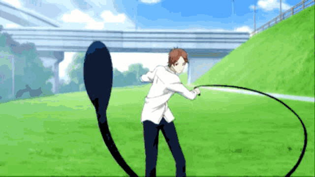 a man in a white shirt is standing on a grassy field