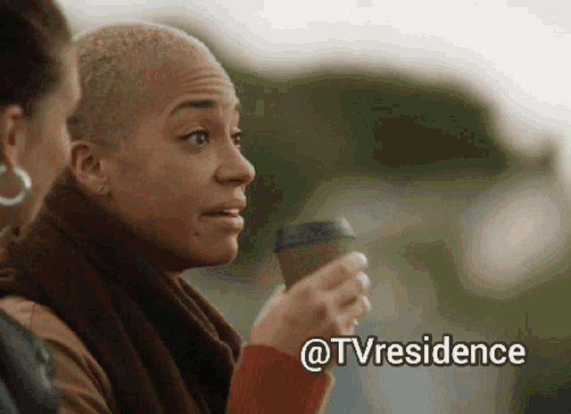 a woman holding a cup of coffee next to another woman with the words @tvresidence above her