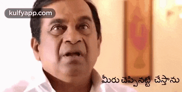 a man in a white shirt is making a funny face and talking in telugu .