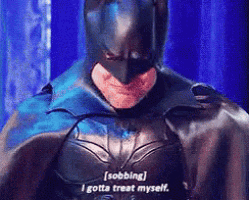 a man in a batman costume is saying " sobbing i gotta treat myself "