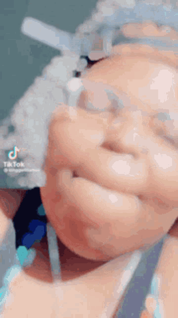 a close up of a person 's face with a tiktok logo in the corner