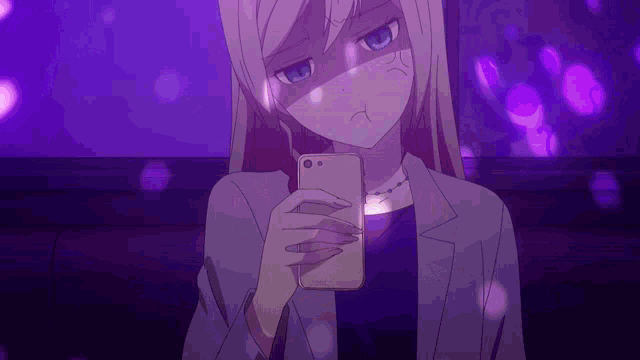 a girl is looking at her phone in a dark room