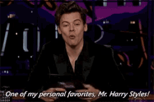 a man in a suit is holding a knife and says one of my personal favorites mr. harry styles !