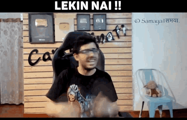 a man is sitting in a chair with the words " lekin nai " written above him