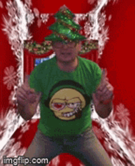 a man wearing a christmas hat and a green shirt with a smiley face on it