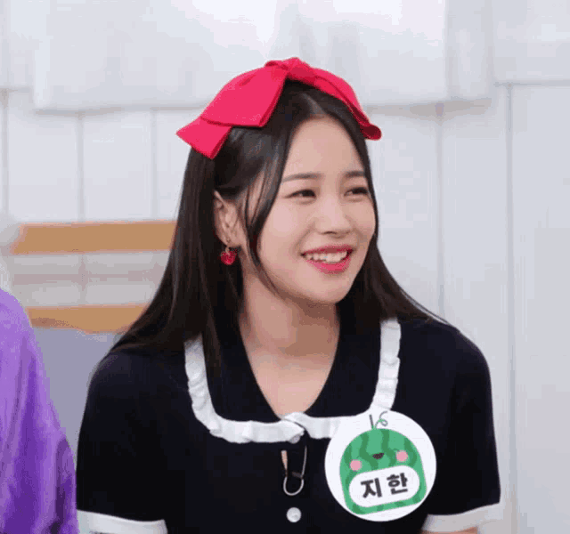a girl wearing a watermelon shaped name tag