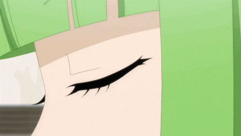 a close up of a person 's eye with a green haircut