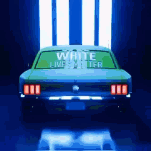 a car with a white lives matter sign on the back window