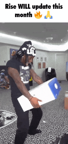 a man is holding a box that says rise will update this month on it