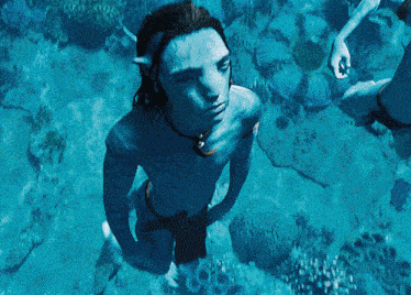 a man with a blue face is swimming in the water