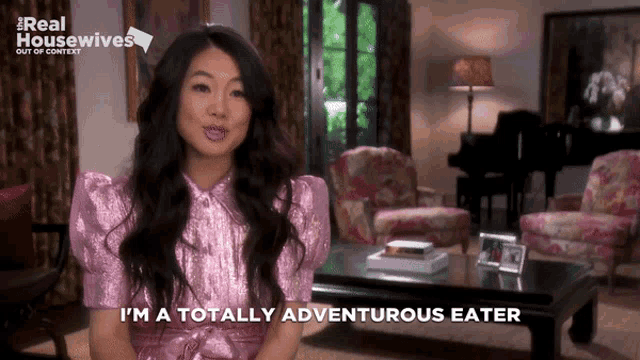a woman says i 'm a totally adventurous eater in front of a living room