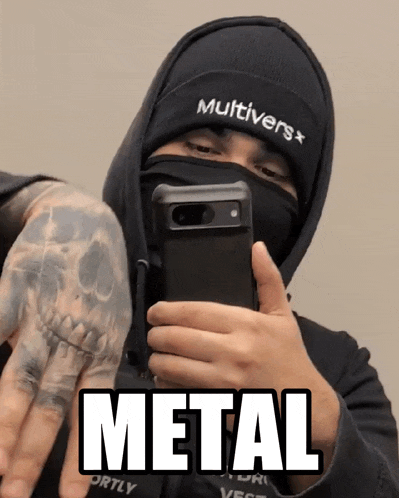 a man taking a picture of himself with the word metal written on the bottom