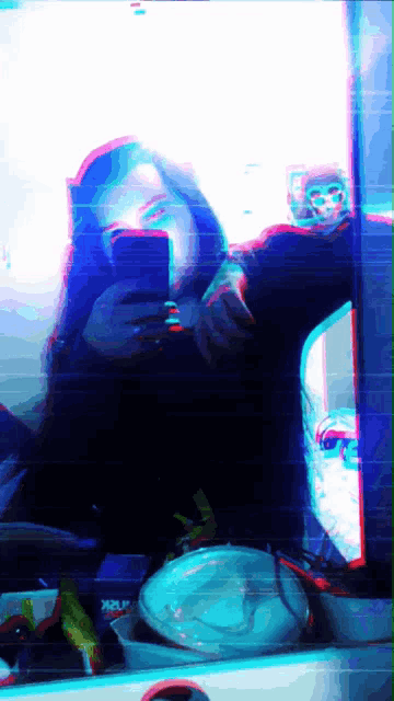 a woman taking a selfie in front of a mirror with a xplr logo on the bottom right