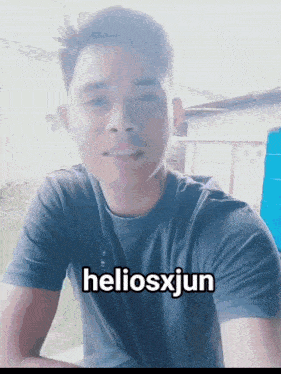 a man wearing a black shirt with the word heliosxjun on it