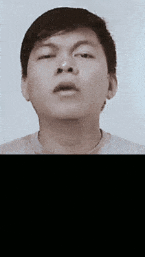 a black and white photo of a young man 's face