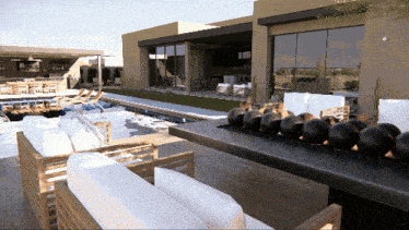 a rendering of a house with a swimming pool and a table with black balls on it