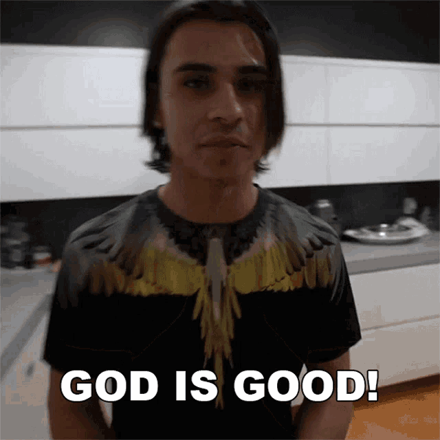 a man wearing a t-shirt that says " god is good "