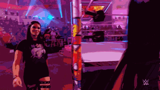 a woman in a wrestling ring with a wwe logo