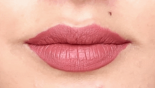 a close up of a woman 's lips with pink lipstick