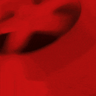 a red frisbee is flying in the air