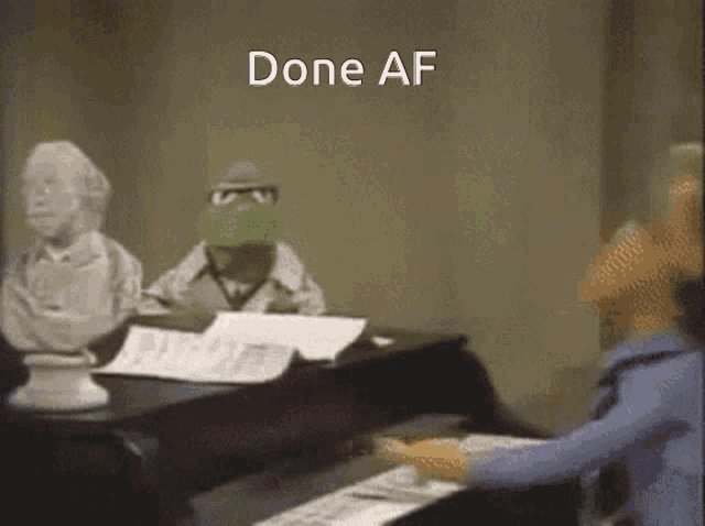 kermit the frog is playing a piano with the words done af behind him