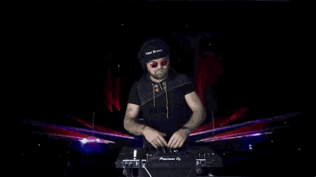 a dj wearing a hat that says laser beam is playing music on a pioneer dj