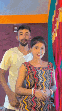 a man and woman are posing for a picture in a room